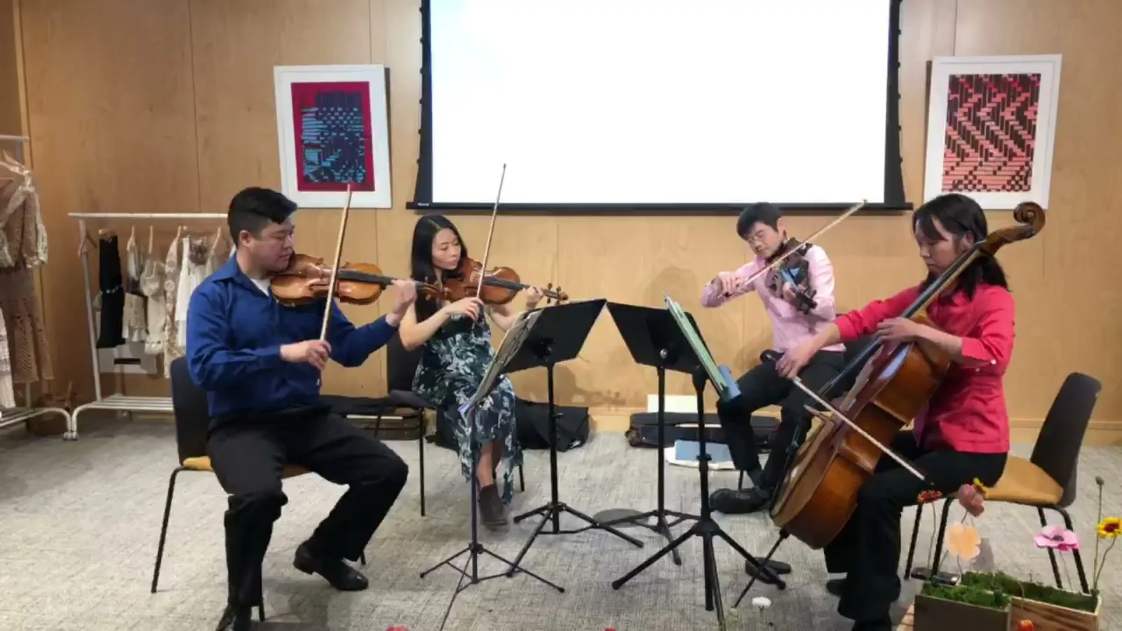 Lumon Quartet seated and performing together