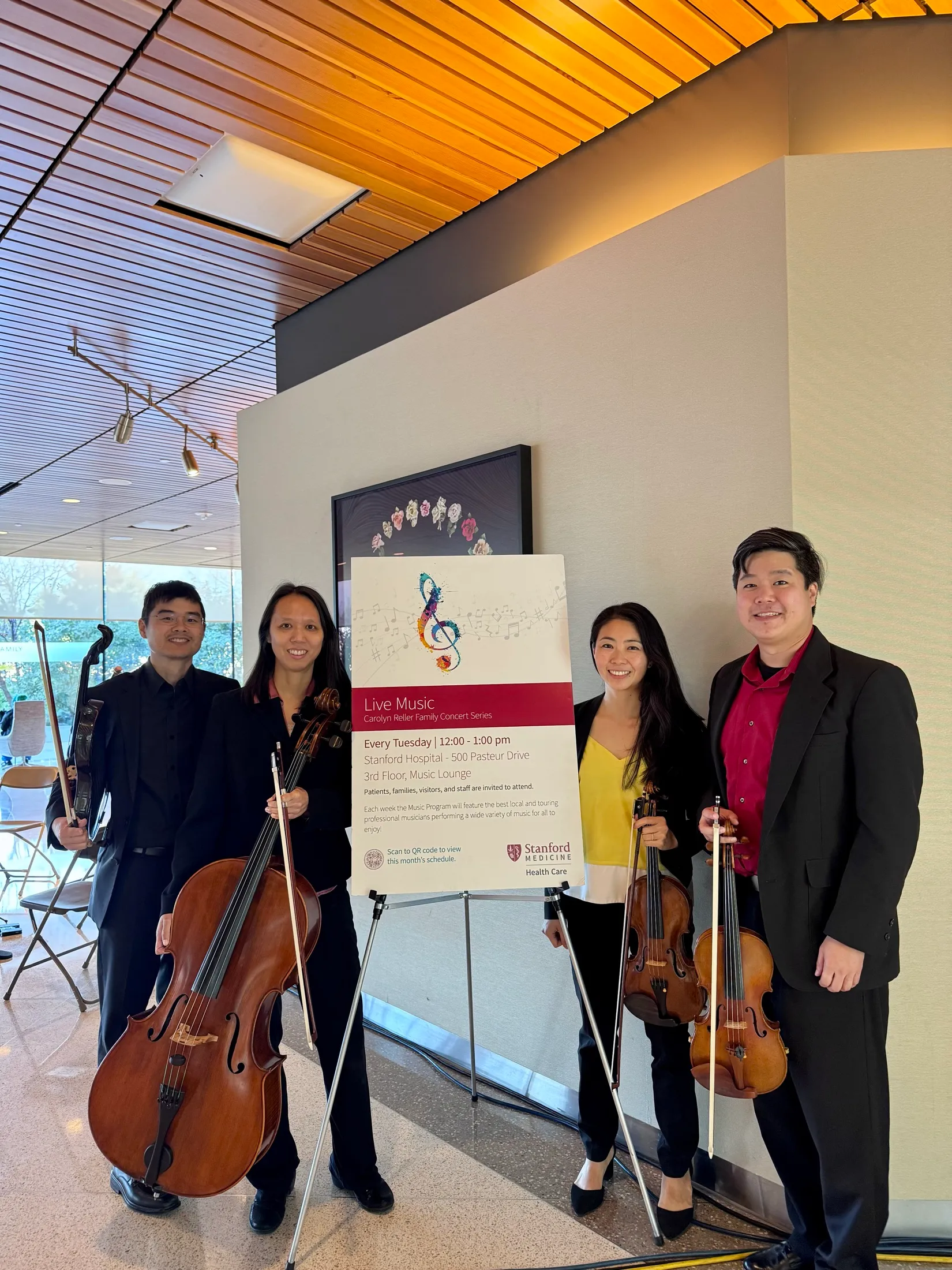 Lumon Quartet posing with their instruments at a Stanford Medicine concert